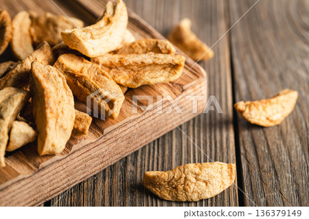 Homemade dried organic apple sliced on wood background. 136379149