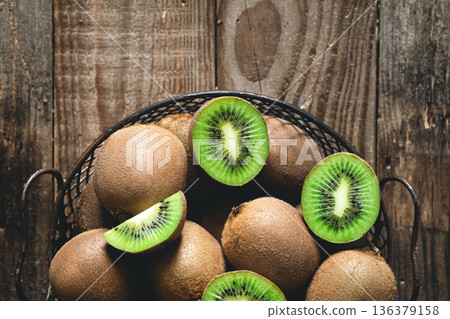 Kiwi fruits on a wooden background, a view of the top. 136379158