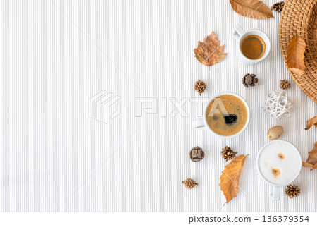 Autumn composition with cups of coffee and leaves on a white background. Autumn composition with cups of coffee and leaves on a white background. 136379354