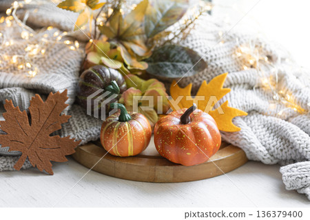 Autumn still life with pumpkins, leaves and knitted element. 136379400