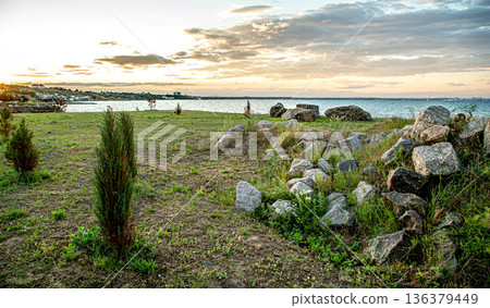 Beautiful landscape by the sea at sunset. Beautiful landscape by the sea at sunset. 136379449