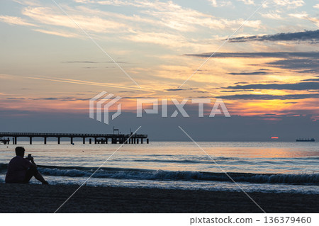 Beautiful seascape with a bridge at sunset. Beautiful seascape with a bridge at sunset. 136379460