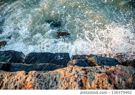 Beautiful sea at sunset near the rocky shore Beautiful sea at sunset near the rocky shore 136379462