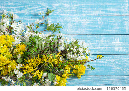 Beautiful spring flowers and blooms on a wooden background. Beautiful spring flowers and blooms on a wooden background. 136379465
