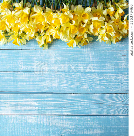Beautiful spring flowers and blooms on a wooden background. Beautiful spring flowers and blooms on a wooden background. 136379466