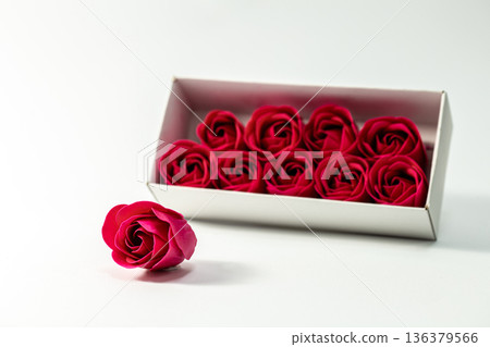 Box with decorative red roses on a white background isolated. Box with decorative red roses on a white background isolated. 136379566