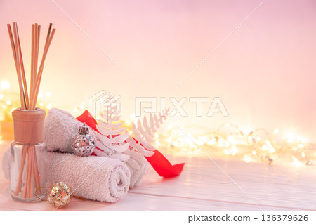 Christmas spa composition with incense sticks, towels and decor details. 136379626