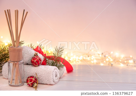 Christmas spa composition with incense sticks, towels and decor details. 136379627
