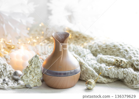 Christmas still life with an aroma diffuser for moisturizing the air, copy space. Christmas still life with an aroma diffuser for moisturizing the air, copy space. 136379629