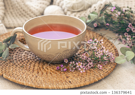 Close-up, big cup of tea and flowers, cozy composition. 136379641