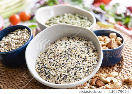 Close-up, a bowl of chia seeds and other healthy foods on the kitchen table. 136379654