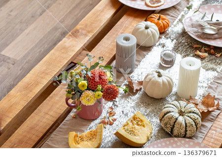 Festive table setting with pumpkins and chrysanthemum flowers. Festive table setting with pumpkins and chrysanthemum flowers. 136379671