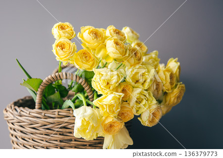 Close-up of yellow spring flowers in a basket. Close-up of yellow spring flowers in a basket. 136379773