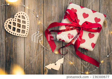 Valentine's Day gift on wooden background with decor details, top view. Valentine's Day gift on wooden background with decor details, top view. 136380677