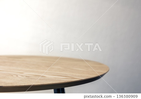 Small indoor wooden table on the background of a white wall, copy space. Small indoor wooden table on the background of a white wall, copy space. 136380909