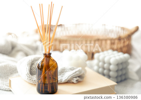 Spa composition with incense sticks and knitted element on a blurred background. 136380986