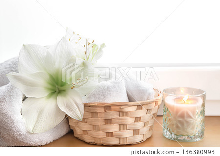 Spa composition with lily flowers and towels in a basket. 136380993