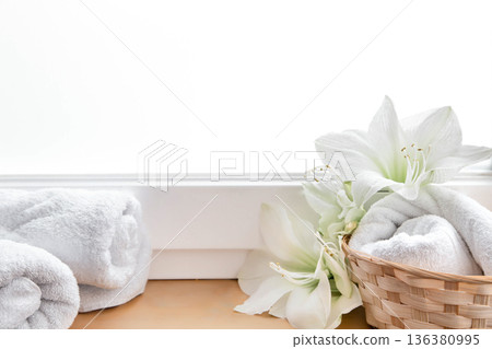 Spa composition with lily flowers and towels in a basket. 136380995