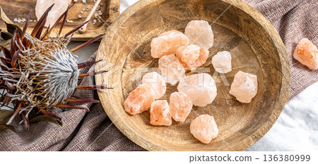 Spa composition with pieces of sea salt in a wooden plate. 136380999