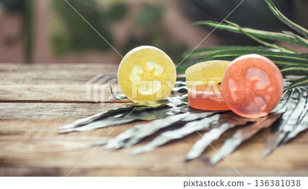 spa handmade soap, composition on tropical leaves, wooden background with space for text spa handmade soap, composition on tropical leaves, wooden background with space for text 136381038