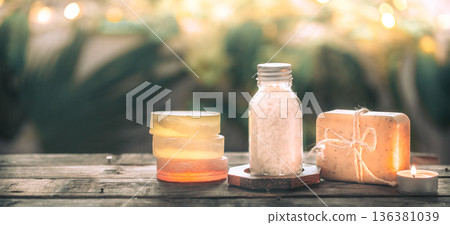 Spa handmade soap with sea salt, composition on tropical leaves with a candle, wooden background Spa handmade soap with sea salt, composition on tropical leaves with a candle, wooden background 136381039