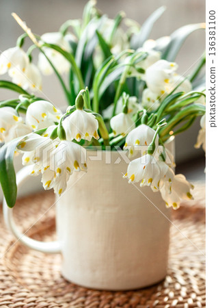 Spring composition with snowdrops in a cup, close-up. Spring composition with snowdrops in a cup, close-up. 136381100