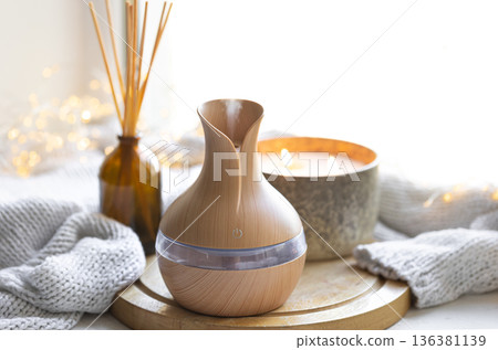 Still life with an aroma diffuser for moisturizing the air and winter decor. Still life with an aroma diffuser for moisturizing the air and winter decor. 136381139