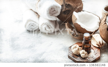still life with coconut oil in a bottle and fresh coconut 136381148