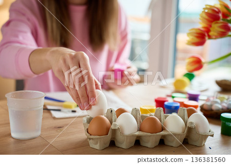 Woman preparing eggs for Easter decorating at home 136381560