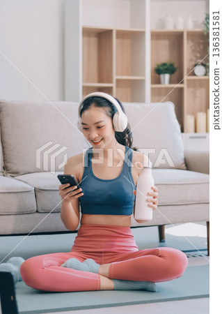 Young Asian sporty attractive people practicing yoga lesson with instructor. Asia group of women exercising healthy lifestyle in fitness studio. Sport activity, gymnastics or ballet dancing class. 136381581