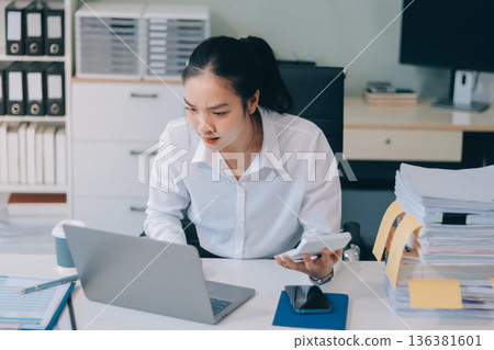 Asian business woman experiences work stress headache in modern office reviewing financial report data analysis overwhelmed professional employee burnout difficult project Asian business woman experiences work stress headache in modern office reviewing financial report data analysis overwhelmed professional employee burnout difficult project 136381601