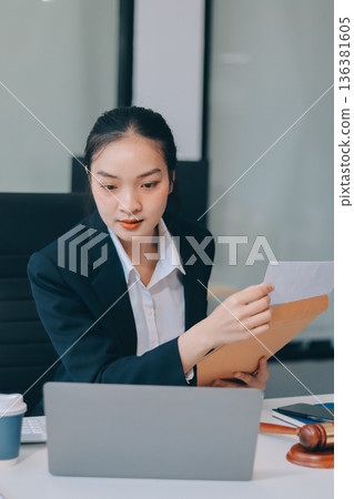 Lawyer explained to the client about the law that must be brought against the court case. Lawyer explained to the client about the law that must be brought against the court case. 136381605