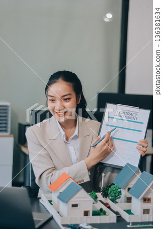 real estate agent home miniature model on documents sale and purchase of apartment notarial deed 136381634