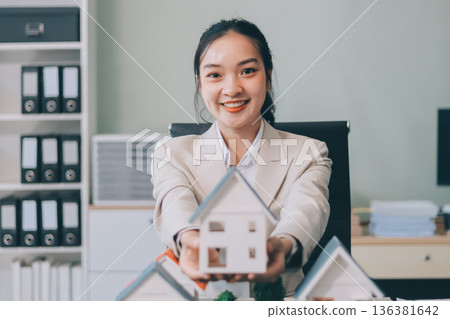 real estate agent home miniature model on documents sale and purchase of apartment notarial deed 136381642