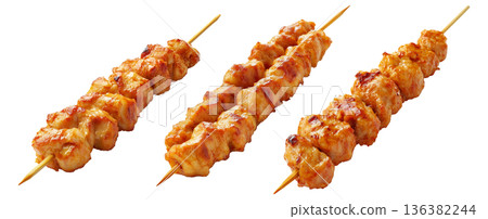 Grilled chicken Satay skewer with a golden brown glaze, isolated on white background, concept of tasty street food Grilled chicken Satay skewer with a golden brown glaze, isolated on white background, concept of tasty street food 136382244