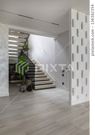 Modern Hallway Interior with Illuminated Staircase and Decorative Screen Modern Hallway Interior with Illuminated Staircase and Decorative Screen 136382354