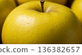 Fresh, ripe golden apple with a visible stem. Healthy, vibrant fruit close-up. 136382657