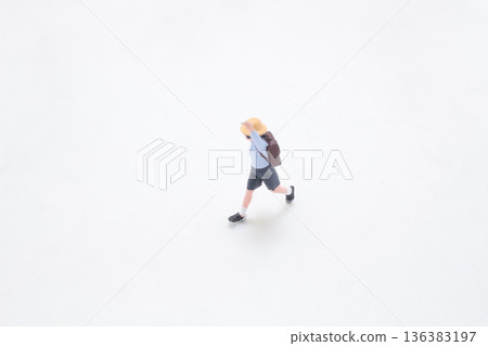 Miniature student runs forward across clean white studio background Miniature student runs forward across clean white studio background 136383197