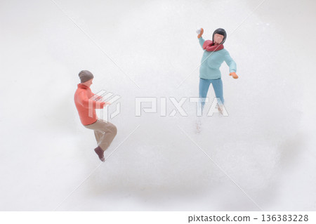 Miniature figures engage in playful snowball fight scene Miniature figures engage in playful snowball fight scene 136383228