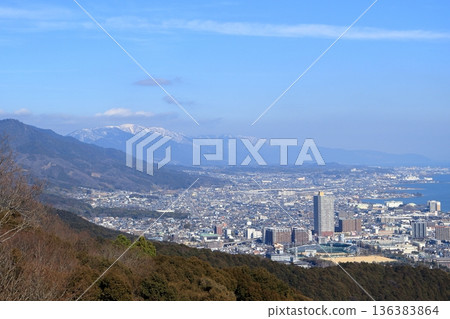 View from Mount Osaka: Otsu city at the foot of the mountain and snow-covered Mount Horai View from Mount Osaka: Otsu city at the foot of the mountain and snow-covered Mount Horai 136383864