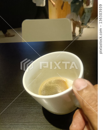 Casual coffee break hand holding white cup espresso cafe table closeup man Casual coffee break hand holding white cup espresso cafe table closeup man 136383939