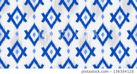 Ikat seamless ethnic traditional pattern with geometric ornament. Abstract rug textured woven print. Retro oriental motif background for decoration and vintage textile design 136384128