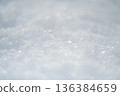 Snowflakes on a snowy field 136384659