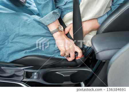 Hands on how to wear a seatbelt (traffic rules, safe driving, traffic safety) Hands on how to wear a seatbelt (traffic rules, safe driving, traffic safety) 136384691