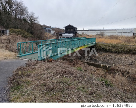 A green bridge over a stream A green bridge over a stream 136384993