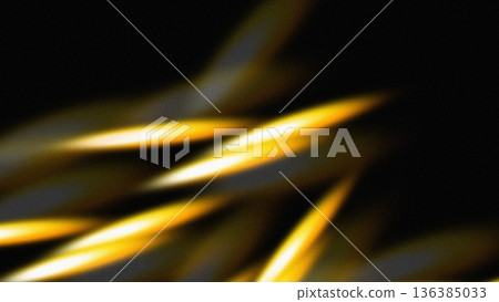 Dynamic golden light streaks black backdrop 136385033