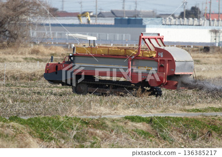 Spreading compost in lotus root fields 136385217