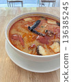 Spicy Thai Tom Yum Soup with Shrimp and Mushrooms in White Bowl 136385245