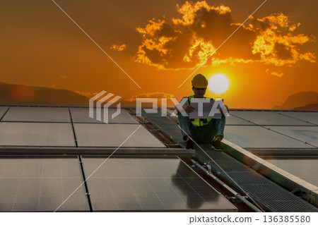Engineer service check installation solar cell on the roof of factory. Engineer service check installation solar cell on the roof of factory. 136385580