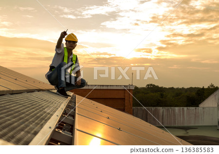Engineer service check installation solar cell on the roof of factory.  136385583